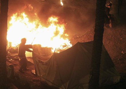 Riot police set fire to tents pitched by anti-Mursi demonstrators at Tahrir Square in Cairo January 25, 2013. REUTERS/Mohamed Abd El Ghany Riot police set fire to tents pitched by anti-Mursi demonstrators at Tahrir Square in Cairo January 25, 2013. REUTERS/Mohamed Abd El Ghany