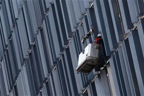 A worker cleans windows on a building in London January 5, 2011. REUTERS/Stefan Wermuth A worker cleans windows on a building in London January 5, 2011. REUTERS/Stefan Wermuth
