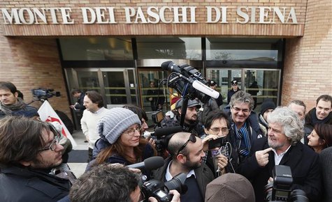 Five-Star Movement activist and comedian Beppe Grillo (R) talks to the media as he leaves the shareholders meeting at Banca Monte dei Paschi Five-Star Movement activist and comedian Beppe Grillo (R) talks to the media as he leaves the shareholders meeting at Banca Monte dei Paschi