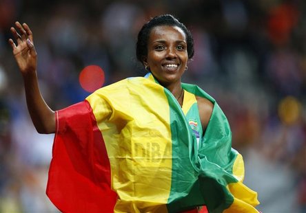 Ethiopia's Tirunesh Dibaba, with her national flag, waves after she won the women's 10,000m final at the London 2012 Olympic Games at the Ol Ethiopia's Tirunesh Dibaba, with her national flag, waves after she won the women's 10,000m final at the London 2012 Olympic Games at the Ol