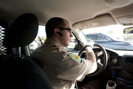 Anthony Monaco, 22, of Phoenix, Arizona, a member of the volunteer posse, drives around Boulder Creek High School in Anthem, Arizona, Januar Anthony Monaco, 22, of Phoenix, Arizona, a member of the volunteer posse, drives around Boulder Creek High School in Anthem, Arizona, Januar