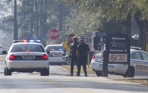 Sheriff Deputies and Houston Police stand on the street to the Lone Star College North Harris campus in Houston, Texas January 22, 2013. REU Sheriff Deputies and Houston Police stand on the street to the Lone Star College North Harris campus in Houston, Texas January 22, 2013. REU
