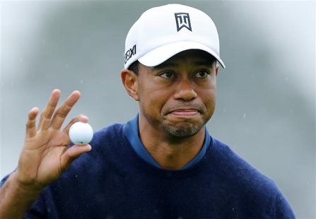 U.S. golfer Tiger Woods holds up his ball after making a birdie to end his round 11-under par during second round play at the Farmers Insura U.S. golfer Tiger Woods holds up his ball after making a birdie to end his round 11-under par during second round play at the Farmers Insura