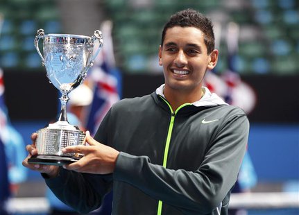 Nick Kyrgios of Australia poses with the trophy after defeating compatriot Thanasi Kokkinakis in their junior boys' singles final match at t Nick Kyrgios of Australia poses with the trophy after defeating compatriot Thanasi Kokkinakis in their junior boys' singles final match at t