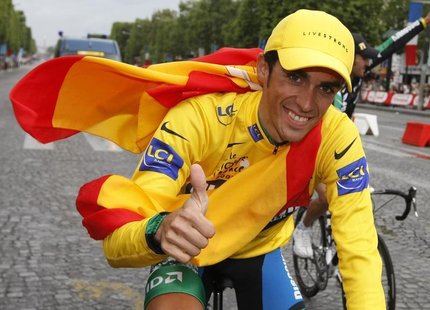 Discovery Channel team rider Alberto Contador of Spain, overall winner, cycles up the Champs Elysees to celebrate his victory after the fina Discovery Channel team rider Alberto Contador of Spain, overall winner, cycles up the Champs Elysees to celebrate his victory after the fina