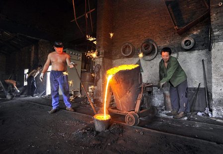 Labourers pour molten iron into a container at a foundry in Xiangfan, Hubei province July 2, 2010. REUTERS/Stringer Labourers pour molten iron into a container at a foundry in Xiangfan, Hubei province July 2, 2010. REUTERS/Stringer