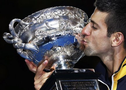 Novak Djokovic of Serbia kisses the Norman Brookes Challenge Cup after defeating Andy Murray of Britain in their men's singles final match a Novak Djokovic of Serbia kisses the Norman Brookes Challenge Cup after defeating Andy Murray of Britain in their men's singles final match a