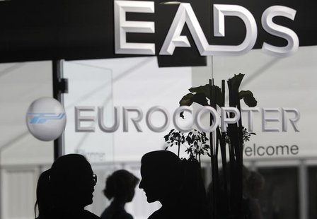 Visitors talk near the welcome desk of the EADS booth at the ILA Berlin Air Show in Selchow near Schoenefeld south of Berlin on September 13 Visitors talk near the welcome desk of the EADS booth at the ILA Berlin Air Show in Selchow near Schoenefeld south of Berlin on September 13