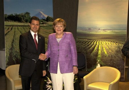 Mexico's President Enrique Pena Nieto (L) shakes hands with Germany's Chancellor Angela Merkel during a private meeting at summit of the Com Mexico's President Enrique Pena Nieto (L) shakes hands with Germany's Chancellor Angela Merkel during a private meeting at summit of the Com