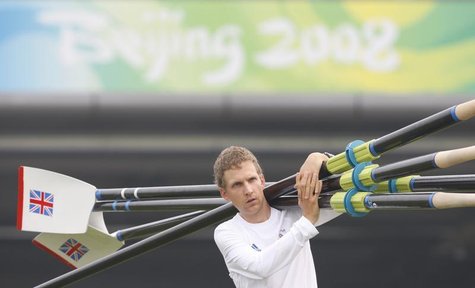 Britain's Men's Eight rowing coxman Acer Nethercott carries oars to the water for a training session at Shunyi Olympic Rowing-Canoeing Park Britain's Men's Eight rowing coxman Acer Nethercott carries oars to the water for a training session at Shunyi Olympic Rowing-Canoeing Park