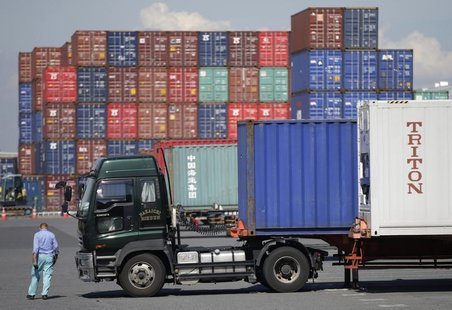 A worker walks at a container depot, near an industrial port in Tokyo September 10, 2012. REUTERS/Toru Hanai A worker walks at a container depot, near an industrial port in Tokyo September 10, 2012. REUTERS/Toru Hanai