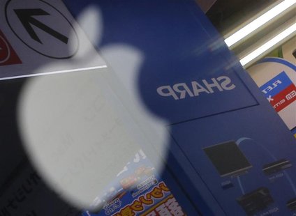 The logo of Sharp Corp is seen reflected on Apple Inc's MacBook Pro at an electronics store in Tokyo January 15, 2013. REUTERS/Toru Hanai The logo of Sharp Corp is seen reflected on Apple Inc's MacBook Pro at an electronics store in Tokyo January 15, 2013. REUTERS/Toru Hanai