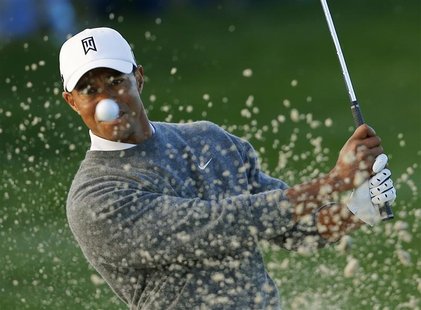 U.S. golfer Tiger Woods hits from a sand trap on the fifth hole during weather delayed fourth round play at the Farmers Insurance Open in Sa U.S. golfer Tiger Woods hits from a sand trap on the fifth hole during weather delayed fourth round play at the Farmers Insurance Open in Sa