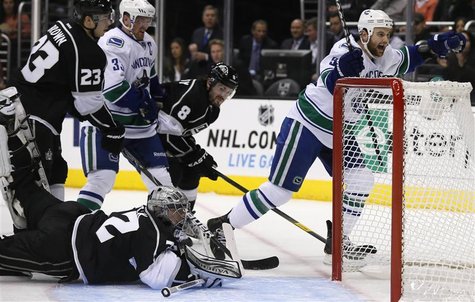 Vancouver Canucks' Zack Kassian (R) scores past Los Angeles Kings goaltender Jonathan Quick (bottom) during the first period of their NHL ga Vancouver Canucks' Zack Kassian (R) scores past Los Angeles Kings goaltender Jonathan Quick (bottom) during the first period of their NHL ga