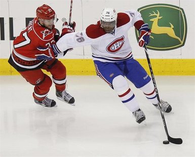 The Montreal Canadiens' P.K. Subban (R) battles the Carolina Hurricanes' Tim Brent for the puck during their NHL hockey game in Raleigh, Nor The Montreal Canadiens' P.K. Subban (R) battles the Carolina Hurricanes' Tim Brent for the puck during their NHL hockey game in Raleigh, Nor