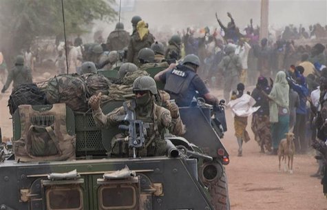 French troops aboard armoured vehicles are greeted by the population as they arrive in Timbuktu in this January 28, 2013 picture provided by French troops aboard armoured vehicles are greeted by the population as they arrive in Timbuktu in this January 28, 2013 picture provided by
