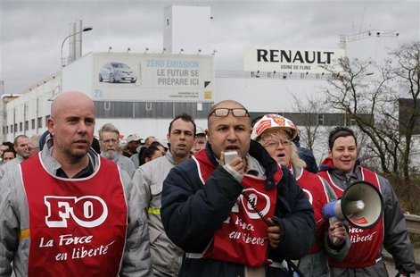 Employees of French car maker Renault demonstrate against the company's new labour deal in front of the Renault car factory in Flins, near P Employees of French car maker Renault demonstrate against the company's new labour deal in front of the Renault car factory in Flins, near P