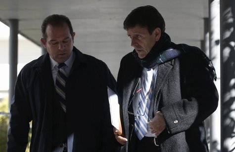 Spanish doctor Eufemiano Fuentes (R) leaves a courthouse on the first day of the high-profile Operacion Puerto doping trial in Madrid, Janua Spanish doctor Eufemiano Fuentes (R) leaves a courthouse on the first day of the high-profile Operacion Puerto doping trial in Madrid, Janua