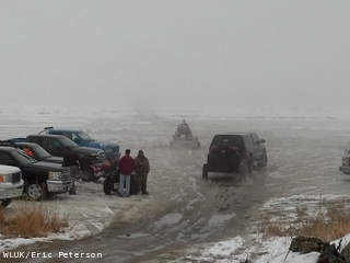 Rescue crews take ATVs into the fog over the bay of Green Bay from Sunset Beach Park in Suamico Jan. 29, 2013, to pull two fishermen off the ice after the truck the men were riding in fell into the water. (courtesy of FOX 11). Rescue crews take ATVs into the fog over the bay of Green Bay from Sunset Beach Park in Suamico Jan. 29, 2013, to pull two fishermen off the ice after the truck the men were riding in fell into the water. (courtesy of FOX 11).