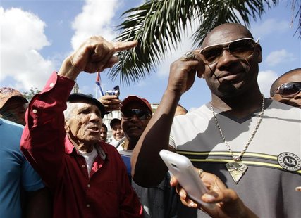 Cuban pitcher Jose Contreras (R) meets fans in Havana January 29, 2013. A decade after he defected to the United States to play Major League Cuban pitcher Jose Contreras (R) meets fans in Havana January 29, 2013. A decade after he defected to the United States to play Major League