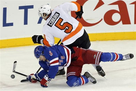 New York Rangers defenseman Anton Stralman (6) dives to stop a shot by Philadelphia Flyers defenseman Braydon Coburn (5) in the third period New York Rangers defenseman Anton Stralman (6) dives to stop a shot by Philadelphia Flyers defenseman Braydon Coburn (5) in the third period