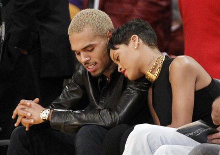 Recording artist Rihanna leans her head on Chris Brown as they sit together courtside at the NBA basketball game between the New York Knicks Recording artist Rihanna leans her head on Chris Brown as they sit together courtside at the NBA basketball game between the New York Knicks