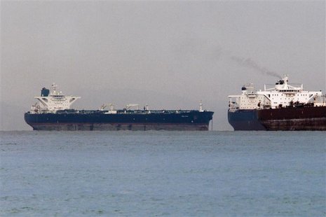 Vessels sail past Malta-flagged Iranian crude oil supertanker "Delvar" (L) anchoring off Singapore March 1, 2012. REUTERS/Tim Chong Vessels sail past Malta-flagged Iranian crude oil supertanker "Delvar" (L) anchoring off Singapore March 1, 2012. REUTERS/Tim Chong