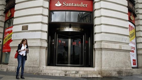 A woman uses her mobile phone outside the main branch of Spain's Santander bank in Madrid October 25, 2012. REUTERS/Sergio Perez A woman uses her mobile phone outside the main branch of Spain's Santander bank in Madrid October 25, 2012. REUTERS/Sergio Perez