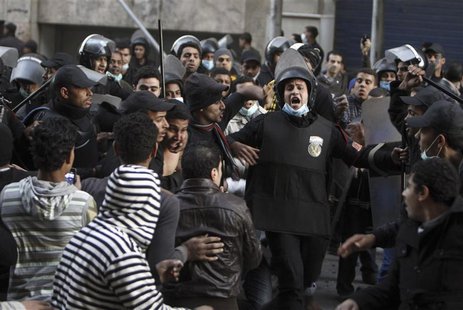 Riot police move in to detain anti-Mursi protesters during clashes in Simon Bolivar Square, which leads to Tahrir Square, in Cairo, January Riot police move in to detain anti-Mursi protesters during clashes in Simon Bolivar Square, which leads to Tahrir Square, in Cairo, January