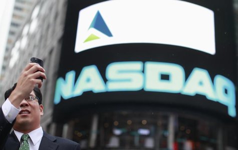 A man takes a photo outside the Nasdaq Market site in New York's Times Square, July 23, 2012. REUTERS/Brendan McDermid A man takes a photo outside the Nasdaq Market site in New York's Times Square, July 23, 2012. REUTERS/Brendan McDermid