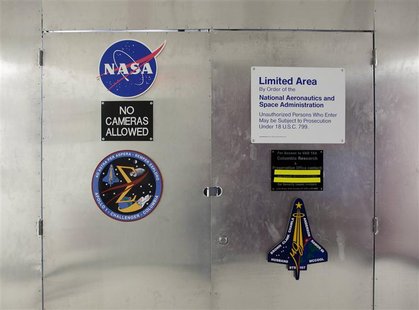 Locked doors, behind which is a room housing pieces of Space Shuttle Columbia, are pictured at the Kennedy Space Center in Florida, January Locked doors, behind which is a room housing pieces of Space Shuttle Columbia, are pictured at the Kennedy Space Center in Florida, January