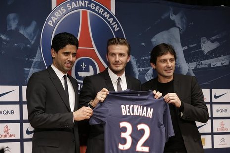 Soccer player David Beckham (C) poses with his new jersey at a news conference in Paris January 31, 2013. Former England captain Beckham has Soccer player David Beckham (C) poses with his new jersey at a news conference in Paris January 31, 2013. Former England captain Beckham has