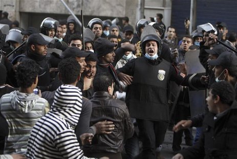 Riot police move in to detain anti-Mursi protesters during clashes in Simon Bolivar Square, which leads to Tahrir Square, in Cairo, January Riot police move in to detain anti-Mursi protesters during clashes in Simon Bolivar Square, which leads to Tahrir Square, in Cairo, January