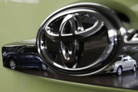 Toyota's Corolla Fielder (L) and Corolla Axio are reflected in a Toyota Forte's logo at the company's headquarters in Tokyo November 5, 2012 Toyota's Corolla Fielder (L) and Corolla Axio are reflected in a Toyota Forte's logo at the company's headquarters in Tokyo November 5, 2012