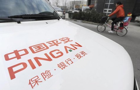 A woman rides a bicycle carrying her child past a car bearing the company logo of Ping An Insurance, in Hefei, Anhui province January 11, 20 A woman rides a bicycle carrying her child past a car bearing the company logo of Ping An Insurance, in Hefei, Anhui province January 11, 20