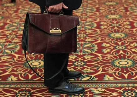 A man holds his briefcase while waiting in line during a job fair in Melville, New York July 19, 2012. REUTERS/Shannon Stapleton A man holds his briefcase while waiting in line during a job fair in Melville, New York July 19, 2012. REUTERS/Shannon Stapleton