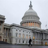 A man walks past the U.S. Capitol Building in Washington December 17, 2012. REUTERS/Joshua Roberts