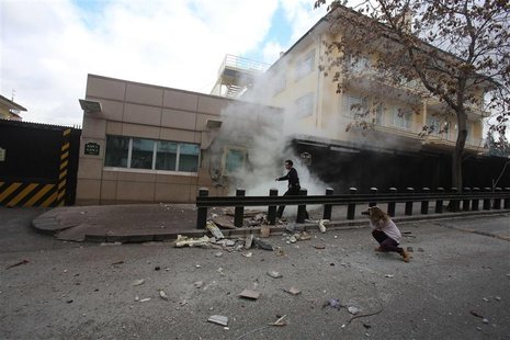 A security officer runs after an explosion at the entrance of the U.S. embassy in Ankara February 1, 2013. A suicide bomber killed a Turkish A security officer runs after an explosion at the entrance of the U.S. embassy in Ankara February 1, 2013. A suicide bomber killed a Turkish