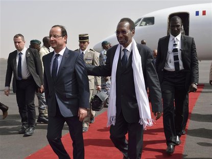 French President Francois Hollande (L) arrives with Mali's interim president Dioncounda Traore at the Bamako airport February 2, 2013. REUTE French President Francois Hollande (L) arrives with Mali's interim president Dioncounda Traore at the Bamako airport February 2, 2013. REUTE