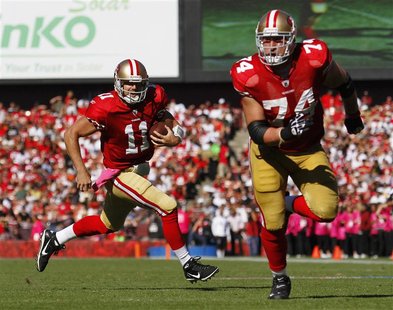San Francisco 49ers quarterback Alex Smith (11) rushes with the ball behind his tackle Joe Staley (74) during the second quarter of their NF San Francisco 49ers quarterback Alex Smith (11) rushes with the ball behind his tackle Joe Staley (74) during the second quarter of their NF