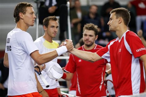 Tomas Berdych (L) of the Czech Republic and his team mate Lukas Rosol (2nd L) shake hands with Stanislas Wawrinka (2R) and Marco Chiudinelli Tomas Berdych (L) of the Czech Republic and his team mate Lukas Rosol (2nd L) shake hands with Stanislas Wawrinka (2R) and Marco Chiudinelli