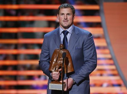 Dallas Cowboys Jason Witten holds the Walter Payton Man of the Year Award after it was presented to him during the NFL Honors award show in Dallas Cowboys Jason Witten holds the Walter Payton Man of the Year Award after it was presented to him during the NFL Honors award show in