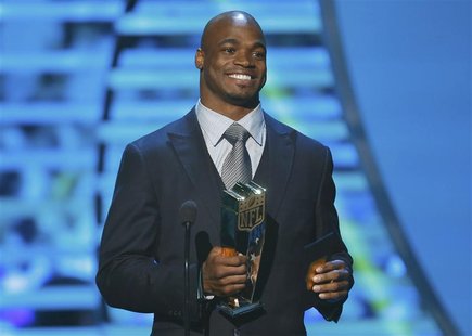 Minnesota Vikings running back Adrian Peterson accepts the NFL MVP award during the NFL Honors awards show in New Orleans, Louisiana Februar Minnesota Vikings running back Adrian Peterson accepts the NFL MVP award during the NFL Honors awards show in New Orleans, Louisiana Februar