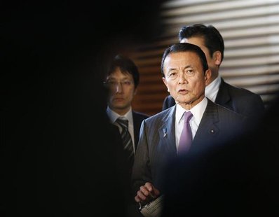 Japan's Finance Minister Taro Aso is seen in-between reporters while he speaks at a joint news conference with Bank of Japan Governor Masaak Japan's Finance Minister Taro Aso is seen in-between reporters while he speaks at a joint news conference with Bank of Japan Governor Masaak