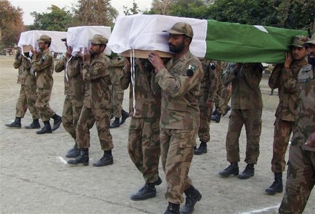 Pakistani soldiers carry the flag-draped caskets of their colleagues killed in an attack by militants during their funeral ceremony in Bannu Pakistani soldiers carry the flag-draped caskets of their colleagues killed in an attack by militants during their funeral ceremony in Bannu