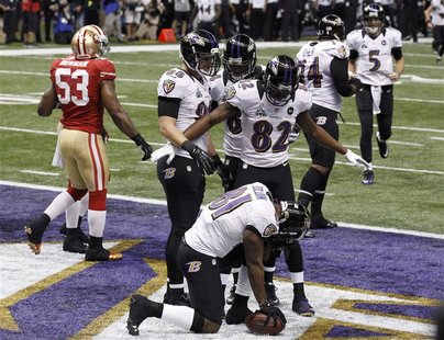 Baltimore Ravens wide receiver Anquan Boldin celebrates his touchdown with teammates Torrey Smith (82), and Dennis Pitta (88) against the Sa Baltimore Ravens wide receiver Anquan Boldin celebrates his touchdown with teammates Torrey Smith (82), and Dennis Pitta (88) against the Sa