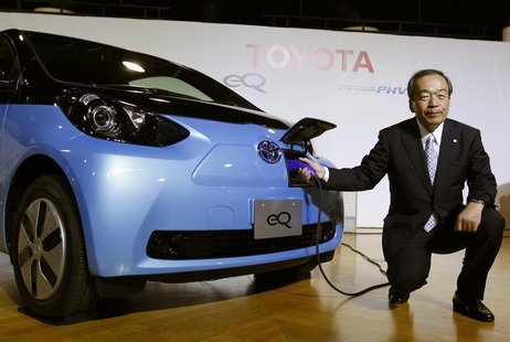 Toyota Motor Corp's Executive Vice President Takeshi Uchiyamada poses next to the company's newly developed compact electric vehicle eQ afte Toyota Motor Corp's Executive Vice President Takeshi Uchiyamada poses next to the company's newly developed compact electric vehicle eQ afte