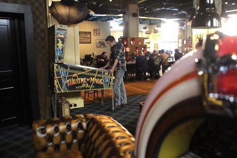 A coder plays a pinball machine game during a break in the Mojang company office in Stockholm January 18, 2013. REUTERS/Ints Kalnins A coder plays a pinball machine game during a break in the Mojang company office in Stockholm January 18, 2013. REUTERS/Ints Kalnins