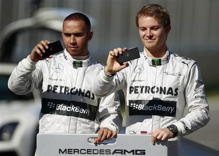 Mercedes Formula One racing driver Lewis Hamilton (L) of Britain and teammate Nico Rosberg of Germany use Blackberry devices during the pres Mercedes Formula One racing driver Lewis Hamilton (L) of Britain and teammate Nico Rosberg of Germany use Blackberry devices during the pres