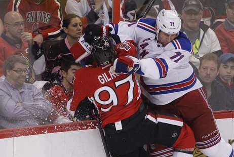 Ottawa Senators' Matt Gilroy (L) is checked into the boards by New York Rangers' Mike Rupp during the first period in Game 3 of the NHL East Ottawa Senators' Matt Gilroy (L) is checked into the boards by New York Rangers' Mike Rupp during the first period in Game 3 of the NHL East